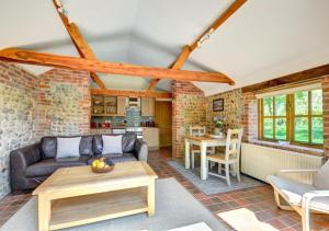 a living room with a couch and a table at Farm Cottage in Sidestrand