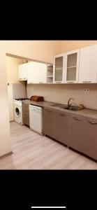 een keuken met witte kasten, een wastafel en een vaatwasser bij Comfort Hotel Taksim in Istanbul