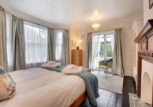 a bedroom with a large bed and a window at Flat 1 Trent House in Cromer