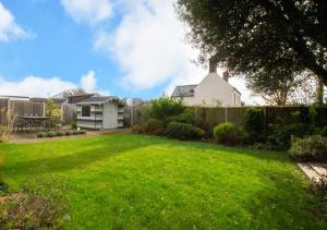 a yard with a fence and a house at Flat 1 Trent House in Cromer