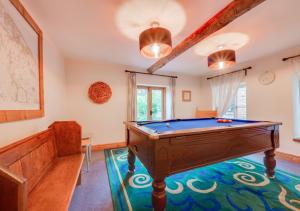 a room with a pool table in a room at Flaxmans Farmhouse in Roughton