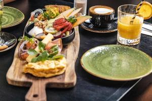 a table with a plate of food and a plate of food at Elements Hotel & Shops Curaçao in Willemstad