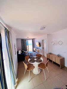 a living room with a table and chairs at Volcano Beach Views & Wifi in Puerto de Santiago