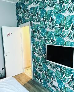 ein Schlafzimmer mit einer blau-weißen Blumenwand in der Unterkunft H Rooms boutique Hotel in Neapel + 37 Fotos