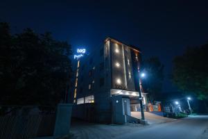 a building with a sign on it at night at TAG HOTELS in Irugūr