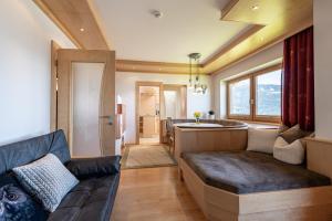 a living room with a couch and a kitchen at Ferienpension Steiner in Weerberg