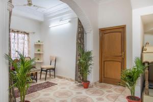 a hallway with potted plants and a wooden door at Host Jatin Kasauli Pine Villa 7oI827o7o3 in Kasauli +24 photos
