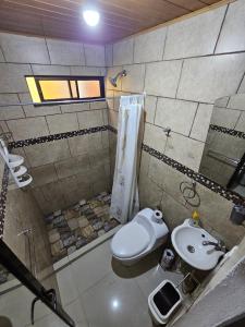 a bathroom with a toilet and a sink at Central 3 Bedroom Quepos Home in Quepos