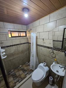 a bathroom with a toilet and a sink at Central 3 Bedroom Quepos Home in Quepos