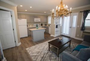 a kitchen and living room with a chandelier at Kenny's Tipperary Inn in Montauk