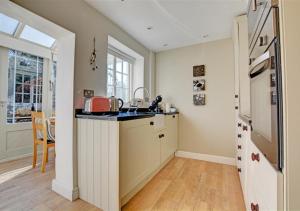 a kitchen with a sink and a counter top at Lavender Cottage in North Creake