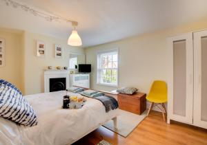 a bedroom with a large bed and a yellow chair at Larkrise in West Runton
