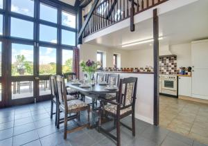 a kitchen and dining room with a table and chairs at Lays Barn in Rockland Saint Peter