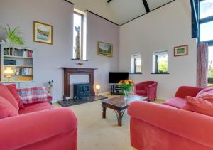 a living room with two red couches and a table at Lays Barn in Rockland Saint Peter