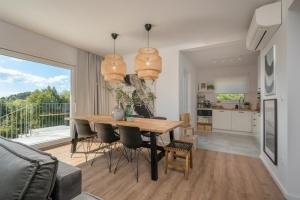 a kitchen and dining room with a table and chairs at Meridiem Holiday Home in Dubrovnik region in Gruda