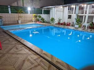 a large swimming pool with blue lights in it at Hotel e Restaurante Rio Mar in Valença