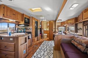 a kitchen and living room of an rv at JT Village Campground - Bunkhouse in Joshua Tree