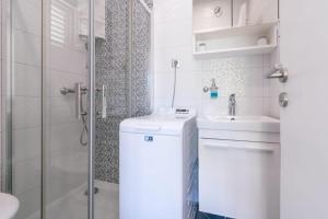 a bathroom with a toilet and a sink and a shower at Apartman Mimi in Baška Voda