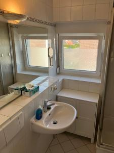 a bathroom with a sink and a mirror at Seestern in Hörnum