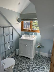un bagno con lavandino e WC di The Old Doctors Retreat- Near Soho Farmhouse a Sandford Saint Martin Altre 27 foto