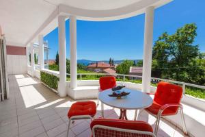 a patio with a table and chairs on a balcony at Two-Bedroom Apartment in Crikvenica VI in Sopaljska