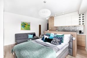 a bedroom with a bed and a couch at Loft Apartments in Gdańsk