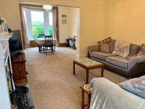 a living room with a couch and a table at North View House Next to Hadrian's Wall in Gilsland