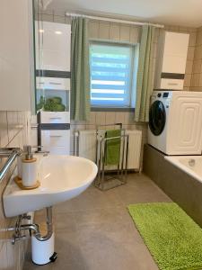 a bathroom with a sink and a washing machine at Ferienhaus Frieda 
