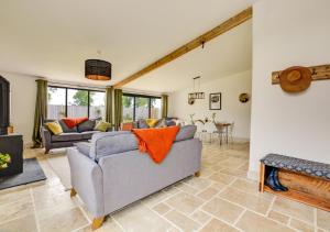a living room with two couches and a fireplace at Muntjac Barn in Briston