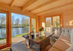 a living room with a table and a couch at Mill Cottage in Elsing