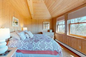 a bedroom with a bed and a wooden ceiling at Birds Nest in Blue Hill