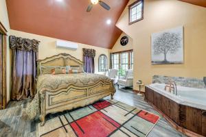 a bedroom with a bed and a bath tub at Blissful Broken Bow Vacation Rental with Fire Pit! in Broken Bow