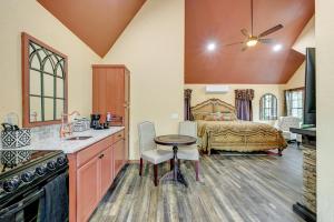 a room with a bed and a kitchen with a table at Blissful Broken Bow Vacation Rental with Fire Pit! in Broken Bow