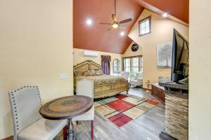 a bedroom with a bed and a table and a television at Blissful Broken Bow Vacation Rental with Fire Pit! in Broken Bow