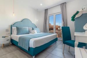 a bedroom with a blue bed and a blue chair at Maison Etoile in Piano di Sorrento