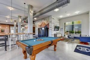 a pool table in a living room with a bar at Bright Stylish Studio Near Downtown in San Antonio