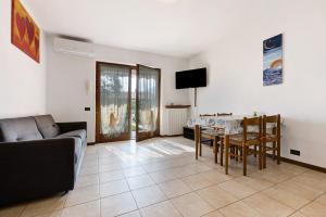 a living room with a table and a couch at Appartamento Assenza 9 in Brenzone sul Garda