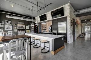 a kitchen with a large island with bar stools at Bright Stylish Studio Near Downtown in San Antonio