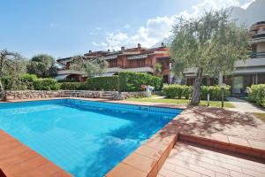 a swimming pool in front of a house at Appartamento Assenza 9 in Brenzone sul Garda