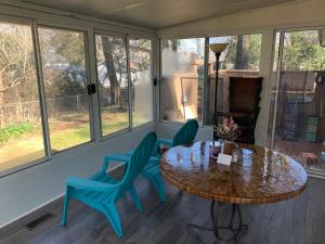 a screened in porch with a table and chairs at Briar Creek Rd bnb in Charlotte