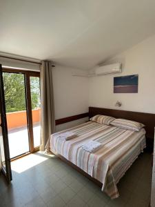 a bedroom with a bed and a sliding glass door at Rooms Danica in Poreč