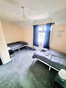 a room with two beds and a window at Bishop Retreat in Bishop Auckland