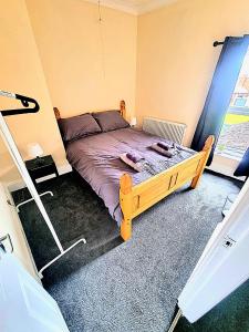 a bedroom with a wooden bed in a room at Bishop Retreat in Bishop Auckland