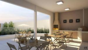 a patio with tables and chairs and a fireplace at 1 quarto e sala com lazer completo in Brasilia