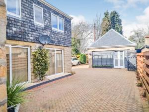 a house with a driveway with a garage at Tanera in Inverness