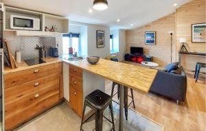 a kitchen with a large wooden counter top in a room at Nice Apartment In Paimboeuf With Wifi in Saint-Paimboeuf