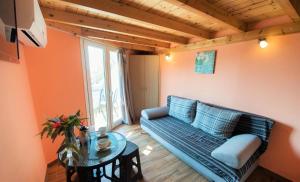 a living room with a couch and a table at Argo Apartments in Vasiliki