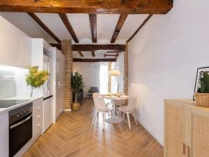 a kitchen with a table and chairs in a room at Beautiful restored house with terrace in Valencia