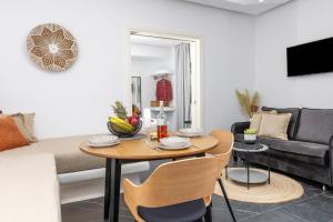 a living room with a table and a couch at Vino luxury suites in Agia Anna Naxos