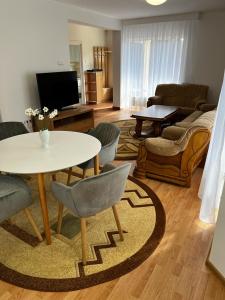 ein Wohnzimmer mit einem Tisch und Stühlen in der Unterkunft Casa Livezeni in Livezeni
